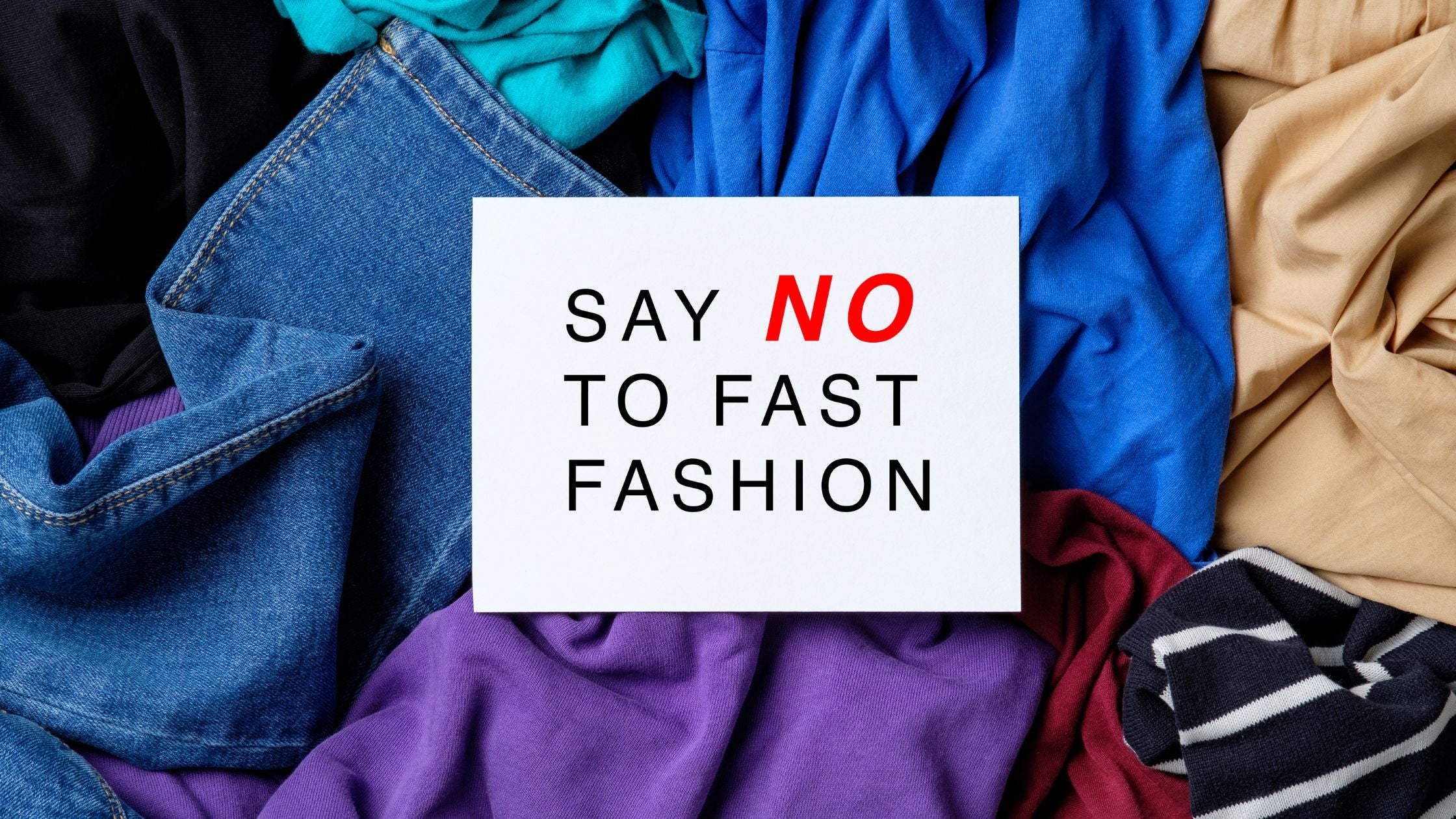 A pile of clothes with Say no Fast Fashion